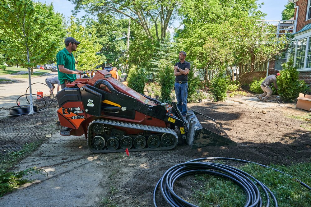 Compact track loader regrading a front yard in Beachwood